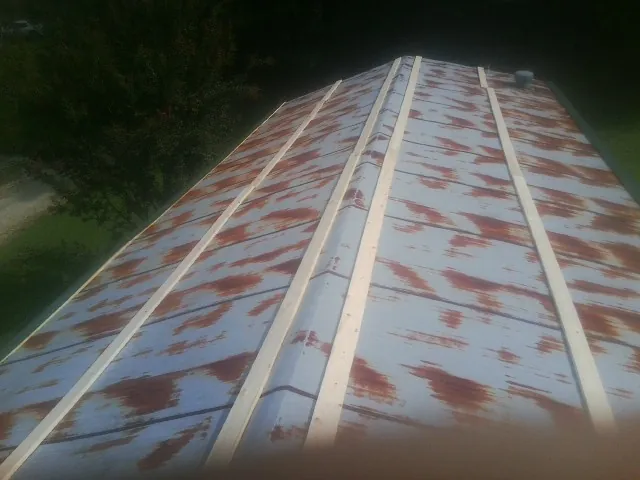 Rusted metal roof panels with new wood purlins before replacement — Storm Damage Roof Repair in Roberta by Roofing Brothers