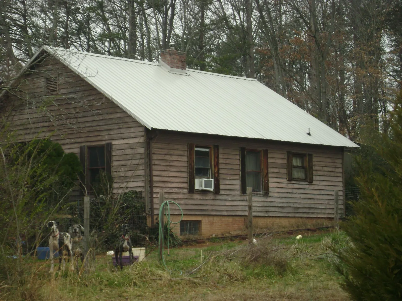White metal roof on an old wood sided farmhouse, from a Metal Roof Installation job in Roberta